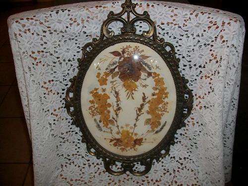 Lovely and ornate metal frame with concave glass