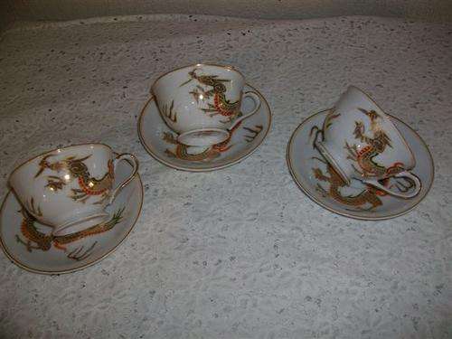 three lovely japanese tea cups and saucers
