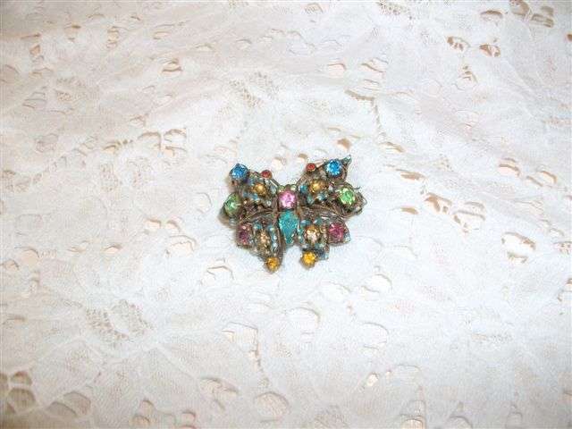 Small filigree butterfly brooch with colourful glass stones..??