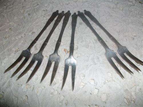 A set of vintage apsotle pickle forks