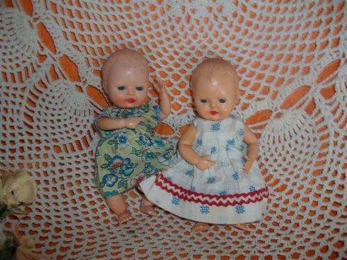 Two small collectable hard plastic rosebud dolls