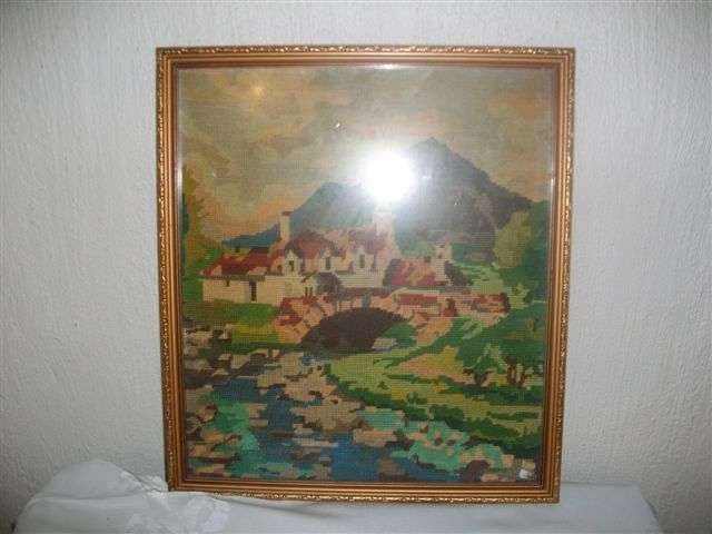 Framed country scence taperstry behind glass