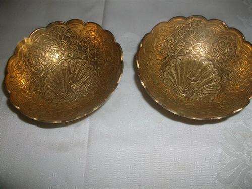 Two small decorative peacock brass bowls