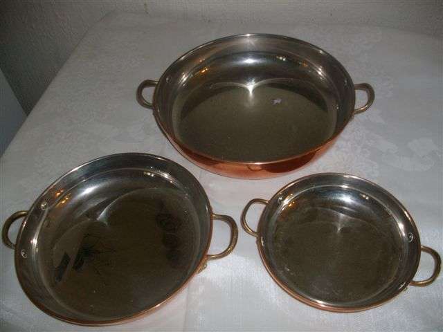 A nice set of three copper plated round pans with handles