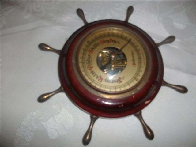 In a form of ships wheel small wooden barometer made in germany