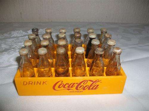 Mini crate filled with small collectable coke cola bottles