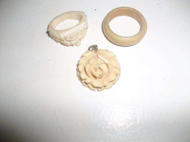 three bone vintage items two rings and a rose pendant