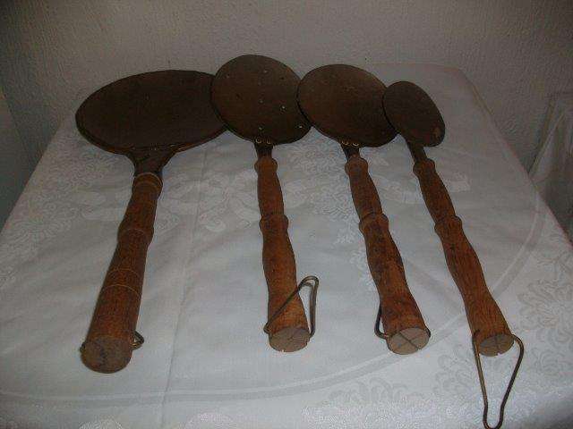 Wooden and brass large wall hanging spoons etc