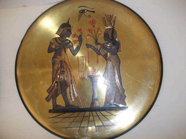Two toned brass and copper wall plate with a eyepation scene