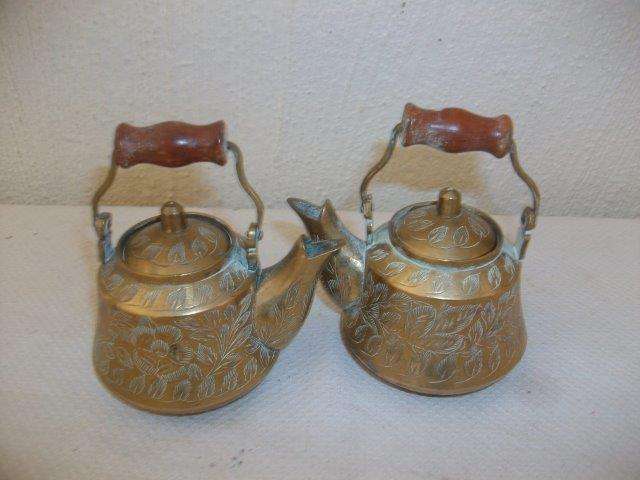A pair of small brass kettles with wooden handles