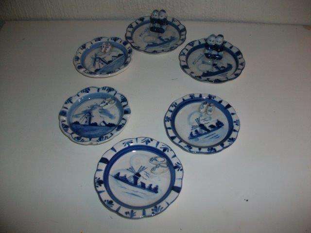 A collection of blue and white delft style pin tray plates