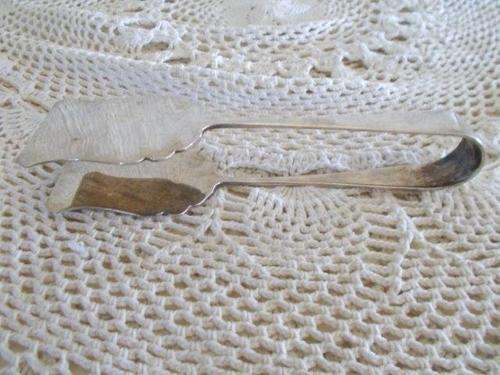 a pair of sliver plated tongs