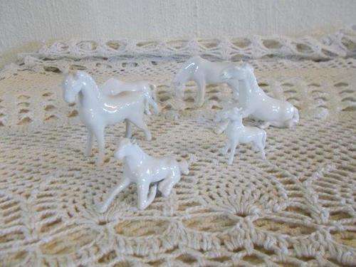 A collection of small white horses figurines