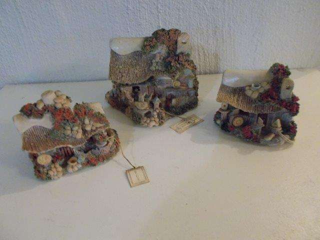 A set of three well made clay cottage homes ornaments