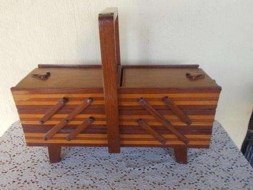 Vintage wooden sewing basket on feet