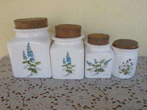 A set of porcelain storage conainters with crock stoppers