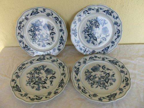 Four pretty blue and white onion pattern bread or salad side plate