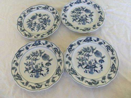 Four pretty blue and white onion pattern cake side plates