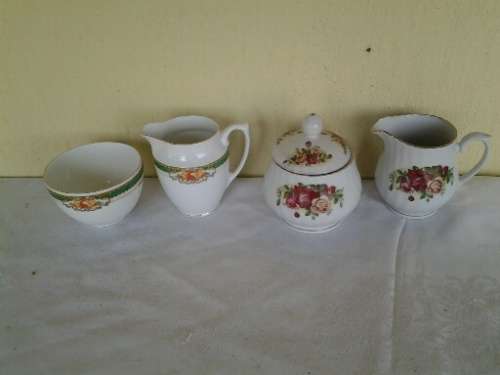 two pretty different porcelain milk and sugar bowls
