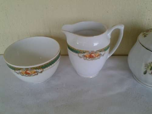 two pretty different porcelain milk and sugar bowls
