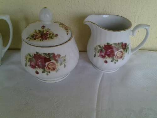 two pretty different porcelain milk and sugar bowls