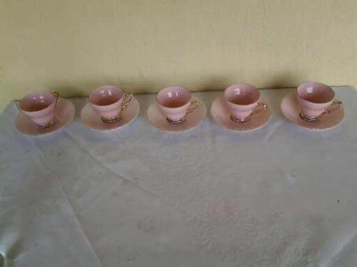a lot of five pretty small pastel pink espresso coffee cups and saucers