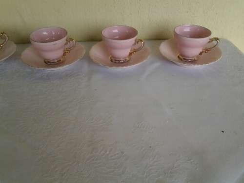 a lot of five pretty small pastel pink espresso coffee cups and saucers