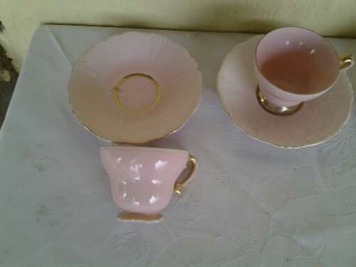 a lot of five pretty small pastel pink espresso coffee cups and saucers