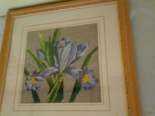 small framed lilac floral tapestry behind glass
