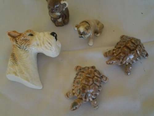 four collectable small ornaments .. dog head .. wade etc
