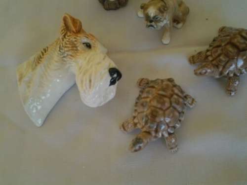 four collectable small ornaments .. dog head .. wade etc