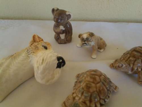 four collectable small ornaments .. dog head .. wade etc