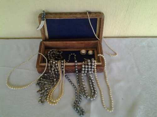 wooden jewelry box filled with some pretty costume pearls