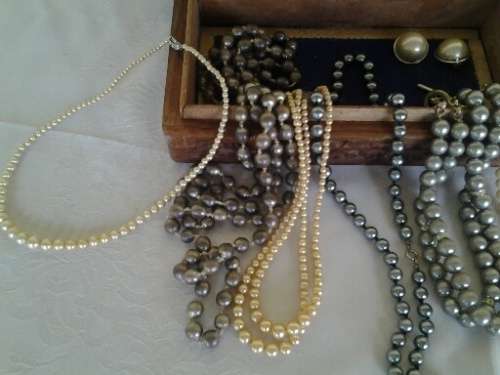 wooden jewelry box filled with some pretty costume pearls