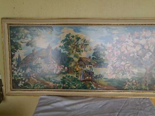 large country side scene tapestry behind glass