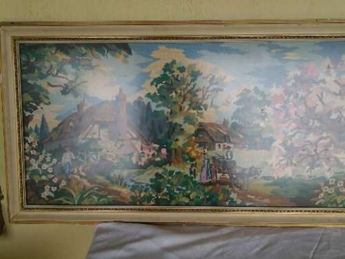 large country side scene tapestry behind glass