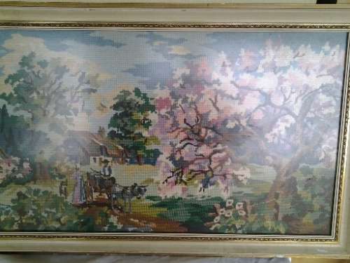 large country side scene tapestry behind glass