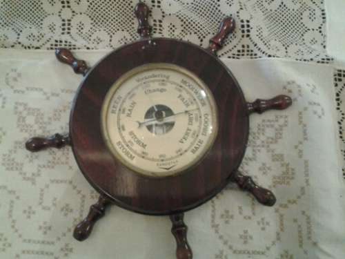 round collectable in a form of ships wheel barometer