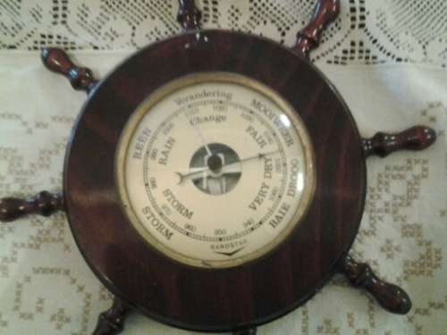 round collectable in a form of ships wheel barometer