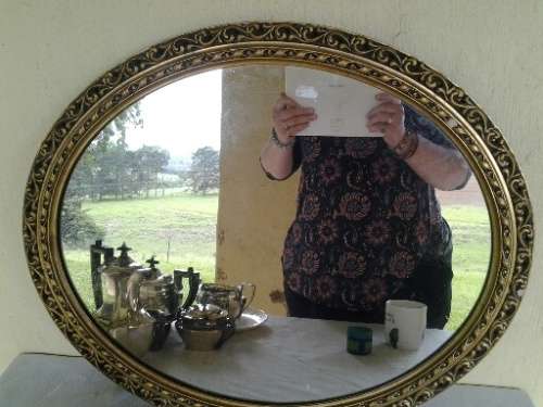 stunning round gold painted wall mirror with some slight damage noted