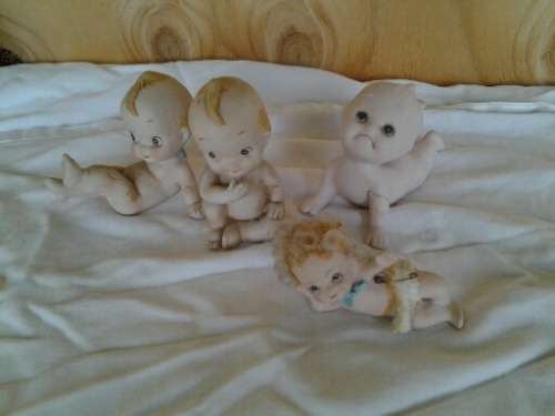 A collection of some  collectable Bisque kewpie style baby ornaments