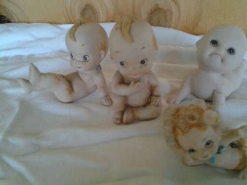 A collection of some  collectable Bisque kewpie style baby ornaments