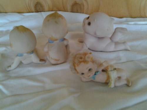 A collection of some  collectable Bisque kewpie style baby ornaments