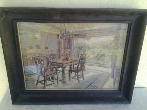A stunning vintage wooden black frame dinning table tapestry behind glass