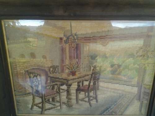 A stunning vintage wooden black frame dinning table tapestry behind glass