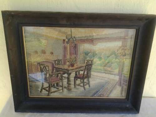 A stunning vintage wooden black frame dinning table tapestry behind glass