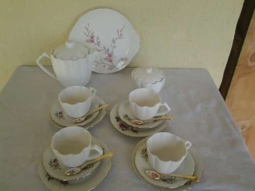 pretty mix and match vintage and modern tea set with gold spoons