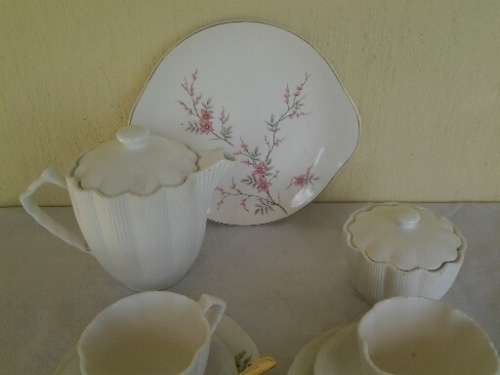 pretty mix and match vintage and modern tea set with gold spoons