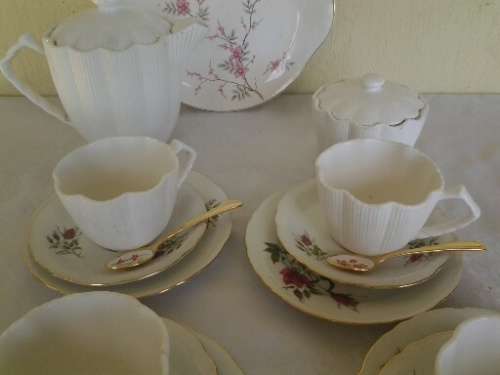 pretty mix and match vintage and modern tea set with gold spoons