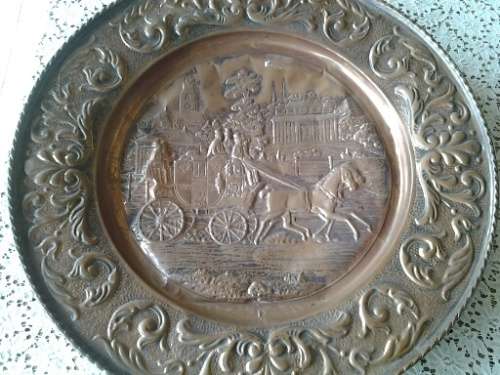 large copper display plate with a horse and carriage scene